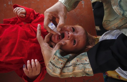 A child receiving a drop of polio vaccine at the UNHCR-supported Jalozai camp on the outskirts of Peshawar in 2012. Thanks in part to UN efforts, polio and smallpox have been largely eradicated. Photo: Reuters