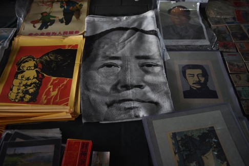 A cloth print featuring a portrait of Mao Zedong lies on the ground at a market in Beijing. In a globalising world shaped by powerful market forces, are national five-year plans typical of command economies still relevant? Photo: AFP