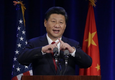President Xi Jinping talks about how the Chinese symbol for the word 'people' resembles two sticks supporting each other during his speech at a banquet in Seattle on September 22. Photo: AP