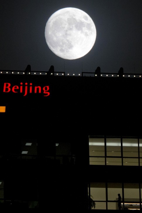 The moon shines over the IFC building in Beijing. Facing pressure to pep up a cooling economy, Chinese leaders are meeting to craft a new long-range blueprint to guide development through the end of this decade. Photo: AP