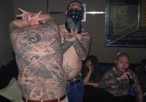Triads have existed in Chinese society for centuries and are often marked with large tattoos of dragons or other tribal signs, as shown in this file photo of Hong Kong gang members. Photo: Handout