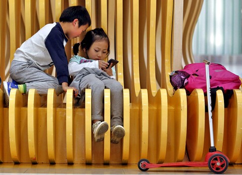 Wang Yi, 34, an office worker and mother of five-year-old Zhou Ziwei (pictured on the left playing with his cousin) said she does not want to have a second child because it takes efforts to raise her son. Photo: Reuters
