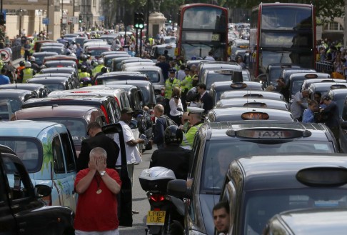 Taxi drivers block a road during a protest against Uber in central London. Photo: Reuters