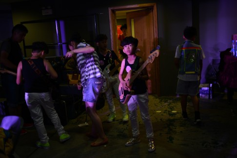  A boy prepares backstage during a rock music competition for children