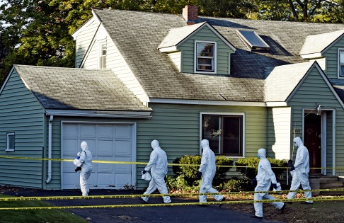 Authorities entering the scene of a quadruple homicide in Guilderland, New York, where Chen Jin, his wife and their two children were found fatally stabbed. Photo: AP