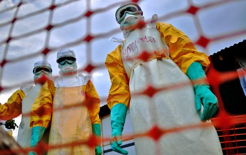 Medecins Sans Frontieres (MSF) medical staff wearing protective clothing treating the body of an Ebola victim at their facility in Kailahun, Sierra Leone last August. Photo: AFP