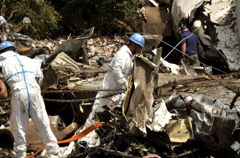 United Nations aviation experts from Japan investigate the wreckage.  Photo: Reuters