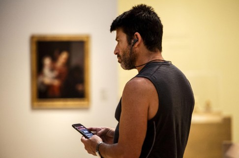 A visitor uses the mobile app at the LA County Museum of Art