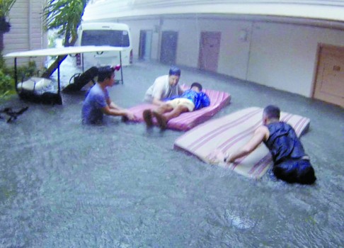 A mattress doubles as a floating stretcher during the typhoon.