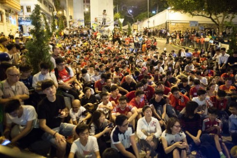 Fans watch the game at a public screening. Photo: AP