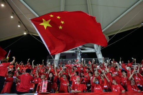 China fans fly the flag for their team. Photo: AFP