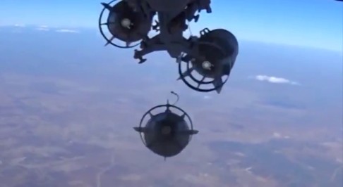 Footage from a camera under a plane shows a Russian military jet dropping bombs in Syria on Tuesday. Russia said on Tuesday it had stepped up air strikes against Islamist State militants in Syria as retribution for blowing up a Russian airliner over Egypt. Photo: Ministry of Defence of the Russian Federation via Reuters