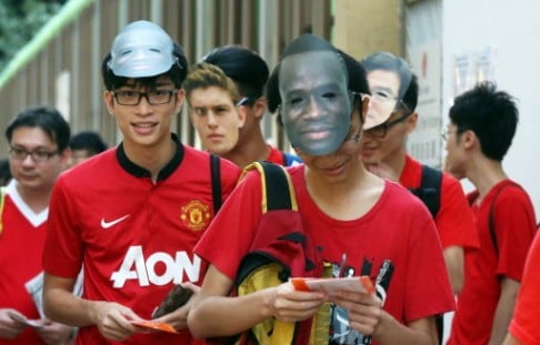 Hong Kong fans wear masks of their 'black-skin, white-skin, yellow-skin' team. Photo: Dickson Lee 