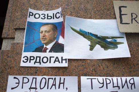 Protesters hurled eggs and stones at the Turkish embassy in Moscow yesterday. Posters showed a portrait of Turkish President Recep Tayyip Erdogan with a caption "Wanted," "Erdogan, Turkey," are left after the protest. Photo: AP