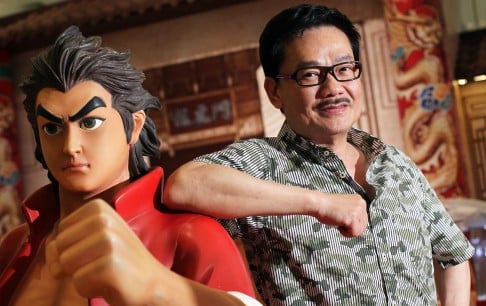 Comic artist Tony Wong Yuk-long poses with a character from Tiger Heroes at his exhibition of celebration the 50th anniversary of his comic work in 2013. Photo: Nora Tam