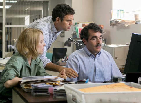 A scene from Spotlight shows McAdams as Pfeiffer, Ruffalo as Rezendes and d'Arcy James as Carroll.