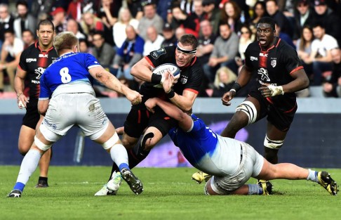 Toulouse prop Imanol Harinordoquy tries to break through a tackle from Saracens' Richard Barrington at Stade Ernest Wallon in Toulouse. Photo: AFP