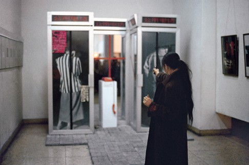 Xiao Lu firing shots at her installation at the “No U-Turn” exhibition, in Beijing, in February 1989.