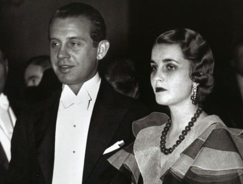 American heiress Barbara Hutton wears a Cartier jadeite necklace (below right) to New York's Metropolitan Opera House, in 1933.