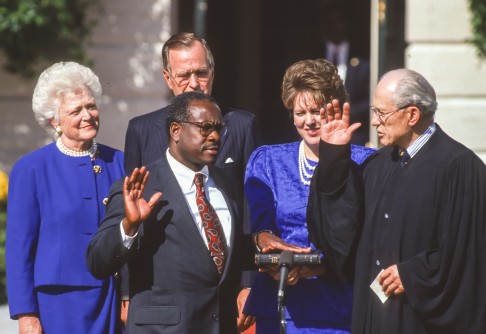 Thomas is sworn in as a US Supreme Court judge by Justice Byron White as then-US president George W. Bush, his wife, Barbara (left), and Thomas' wife, Virginia Lamp Thomas look on.