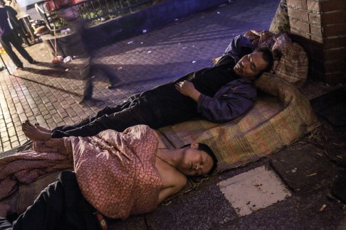 Having failed to find work in the city, displaced farmers sleep on the street in Chongqing, in 2013.