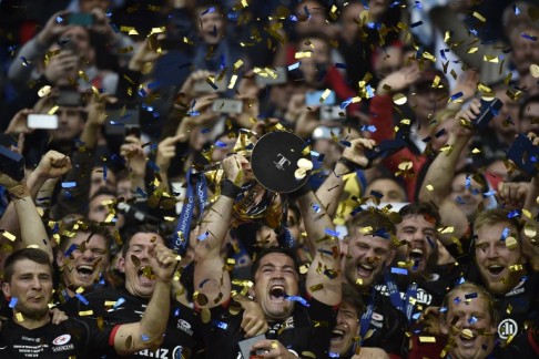 Saracens players celebrate with the trophy after winning the 2016 European Rugby Champions Cup final against Racing 92 at the Parc Olympique Lyonnais stadium in eastern France on Saturday.