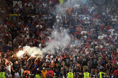 Russia fans set off a flare against England. Photo: AFP