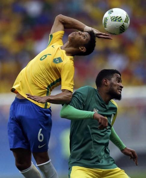 Brazil’s Douglas Santos (left) vies for the ball with South Africa’s Tashreeq Morris at the Mane Garrincha Stadium in Brasilia. Photo: Reuters