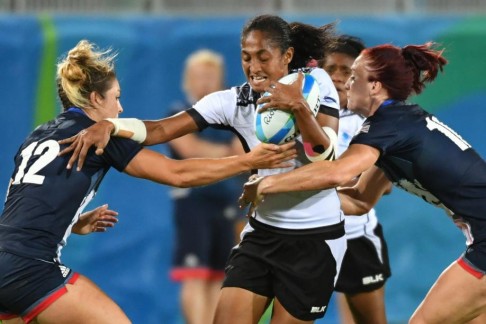 Fiji’s Tima Tamoi gets wrapped up by the Great Britain defence. Photo: AFP