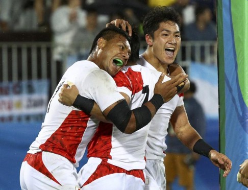 Japan’s Teruya Goto (right) celebrates with a team-mate after scoring the game winning try against France. Photo: Reuters
