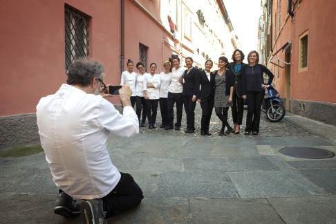 Chef Massimo Bottura takes a photograph of his hardworking Osteria Francescana team.
