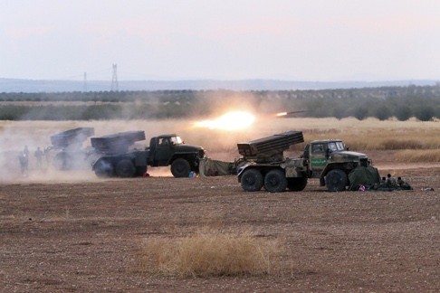 Syrian army rocket launchers fire near the village of Morek in Syria. Photo: AP