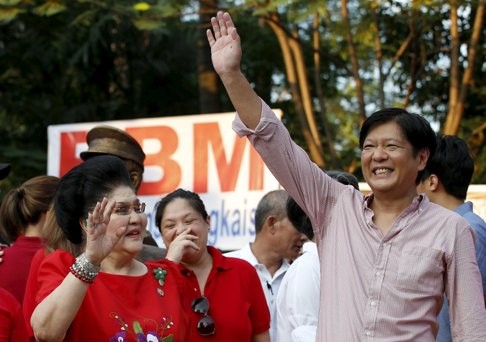 Former Philippine first lady Imelda Marcos and her son Senator Ferdinand Marcos Jr wave to supporters after he announced his vice-presidential bid. Photo: Reuters