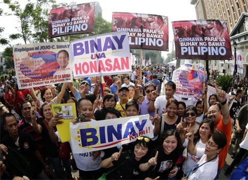 Filipino supporters of vice-president Jejomar Binay cheer during the filing of certificates of candidacy in Manila on Monday. Photo: EPA