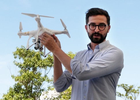 Michael Perry, director of communication at Drone maker DJI, demonstrates its popular Phantom 3 drone at Hong Kong Science and Technology Park in August. Photo: Bruce Yan
