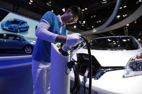 An exhibitor charges an electric car during the Beijing new energy automobile industry exhibition last Wednesday. The three-day expo showcased new energy automobile products as China aims to boost its low-carbon economy. Photo: EPA