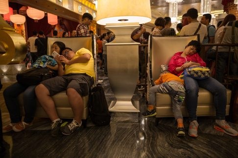 Visitors take a rest inside Melco Crown Entertainment’s Studio City casino and resort. Photo: EPA