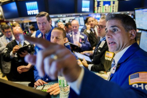 Traders work on the floor of the New York Stock Exchange shortly after the opening bell in New York on Wednesday. Photo: Reuters