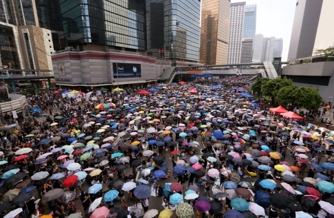 Protesters hold umbrellas at a protest site during the early days of the Occupy protest in Admiralty last year.