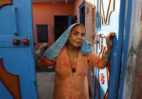 A bruised Asgari Begum, the mother of the Muslim farmer labourer killed by a mob, stands by the entrance of her home in Bisara in Uttar Pradesh. Photo: AP