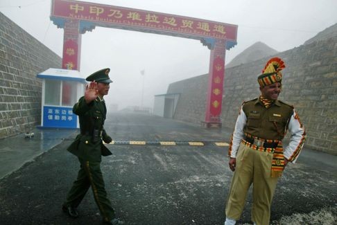 A Chinese soldier and an Indian soldier were seen in this photograph taken in 2008, standing on the Chinese side of the Nathu La border crossing between the two countries. Photo: AFP