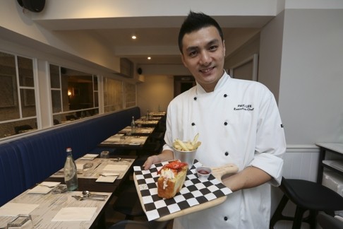Paul Lee, executive chef of Lobster & Mussels, with his take on a lobster roll. Photo: Edward Wong