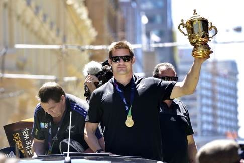 Richie McCaw holds the Webb Ellis Cup during a parade by the team through the central business district of Wellington. Photo: AFP