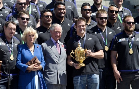 Richie McCaw holds the Webb Ellis trophy with Britain's Prince Charles and the Duchess of Cornwall during a welcome home parade for the All Blacks. Photo: AP