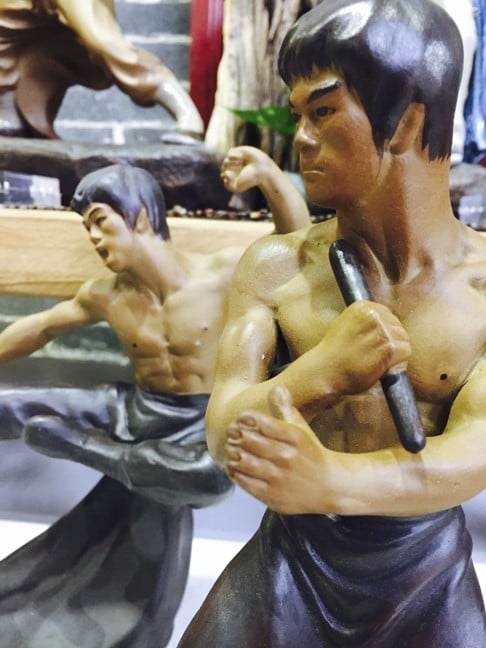 Ceramic figurines of Bruce Lee in a shop at 1506 Creative City in Foshan .