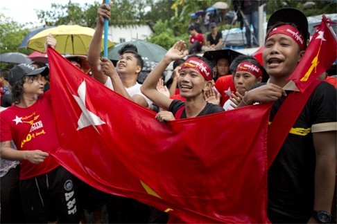 Braving rain, supporters of Myanmar's National League for Democracy outside NLD headquarters in Yangon. Photo: AP