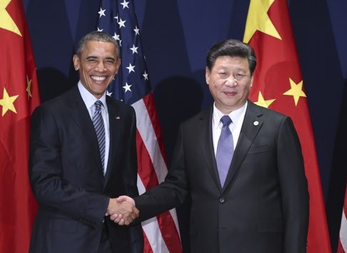 President Xi Jinping and US President Barack Obama meet in Paris on Monday. Photo: Xinhua