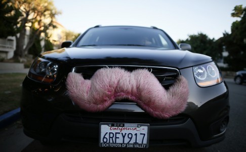 Lyft’s pink mustache was the first branding the company used until 2015, when it switched to a smaller, glowing magenta mustache that sits on a driver’s dashboard. Photo: Reuters