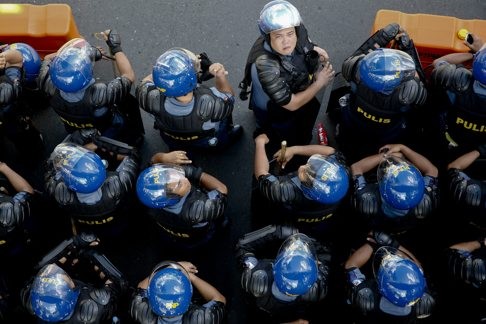 Filipino riot police cordon off a street in Manila after dispersing a large crowd staging a protest against Apec. At the forum, military strategy overshadowed the economic momentum which should bring Washington and Beijing closer. Photo: EPA