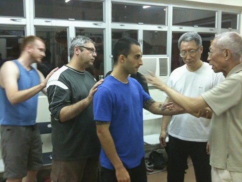 Chu Shong-tin (right) teaches Nima King (in blue shirt) wing chun. Photo: courtesy of Nima King